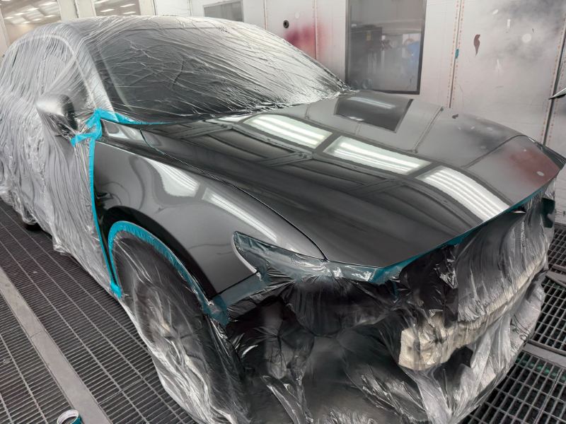 Glossy freshly painted bonnet and guard on the masked hatchback