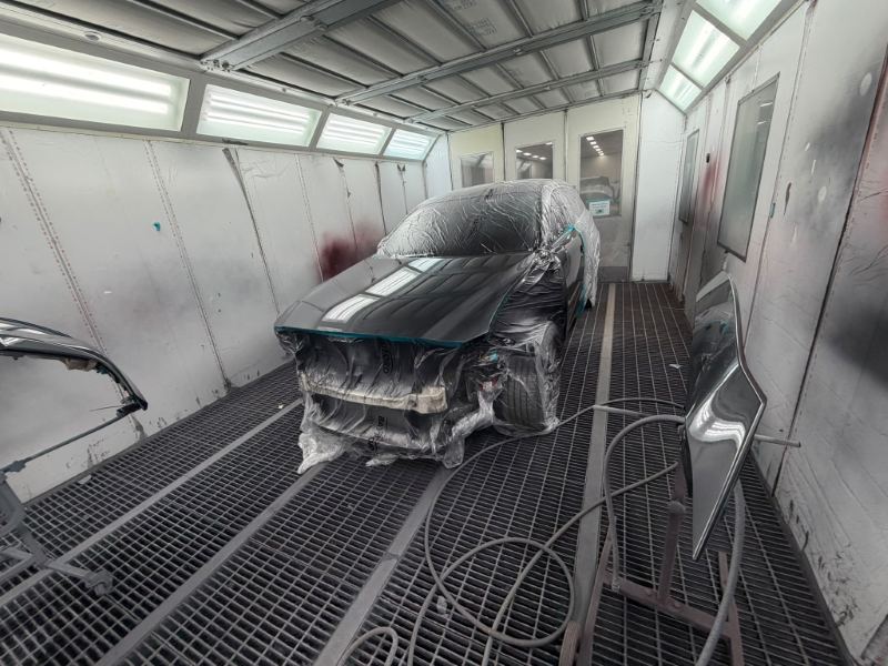 Wide view of the spray booth with the hatchback and painted panels