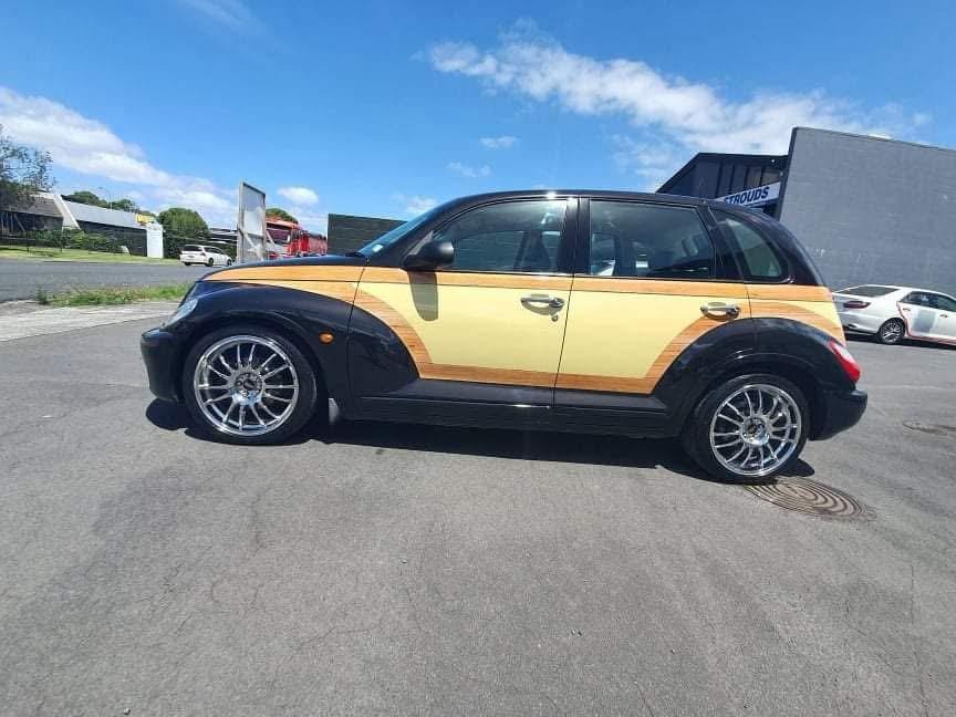 Side profile of the finished PT Cruiser outside, showing the full woodie design