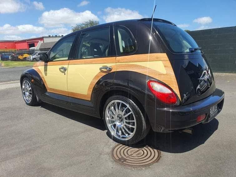 Rear three-quarter view of the finished car in the sun