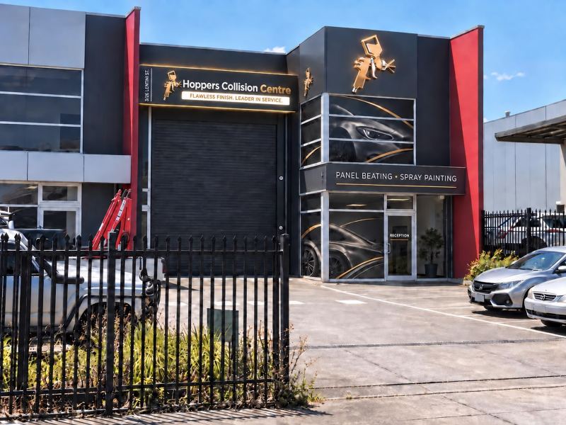 The Hoppers Collision Centre workshop at 3/26 Lentini St, with its gold spray-gun signs