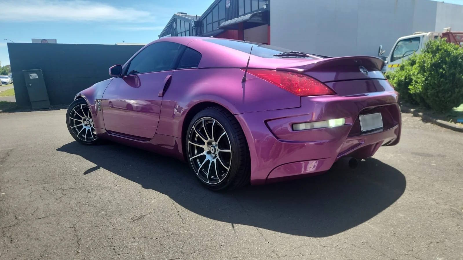 Metallic purple sports car with a freshly resprayed, high-gloss finish